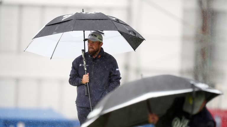 Shane Lowry shelters from the rain on day two of The Open at Royal Portrush